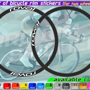 May include: A set of black bicycle rim stickers for two wheels featuring the white text Roval. The image includes a color chart with fourteen numbered options ranging from black and white to metallic gold, pink, and violet, labeled available colors.