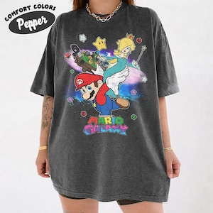 May include: A white ceramic mug with a black handle and the text "But First, Coffee" in a black, bold font. The mug is sitting on a white surface. The mug appears to be 12 ounces.