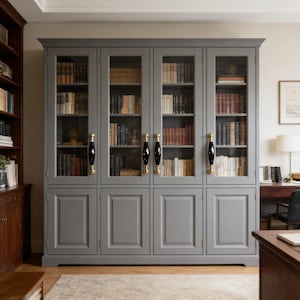 May include: A large, grey bookcase with glass doors filled with books. The bookcase has four sections with black and gold handles. The books are of various sizes and colours, creating a classic library aesthetic.