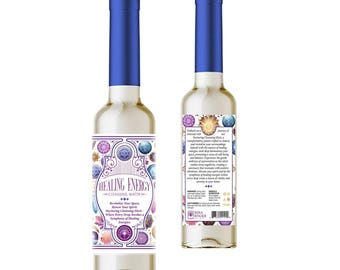 May include: Two bottles of Healing Energy Cleansing Water with blue caps. The bottles have a white label with the words "Healing Energy" and decorative geometric designs in purple, blue, and gold. The bottles are filled with a clear liquid.