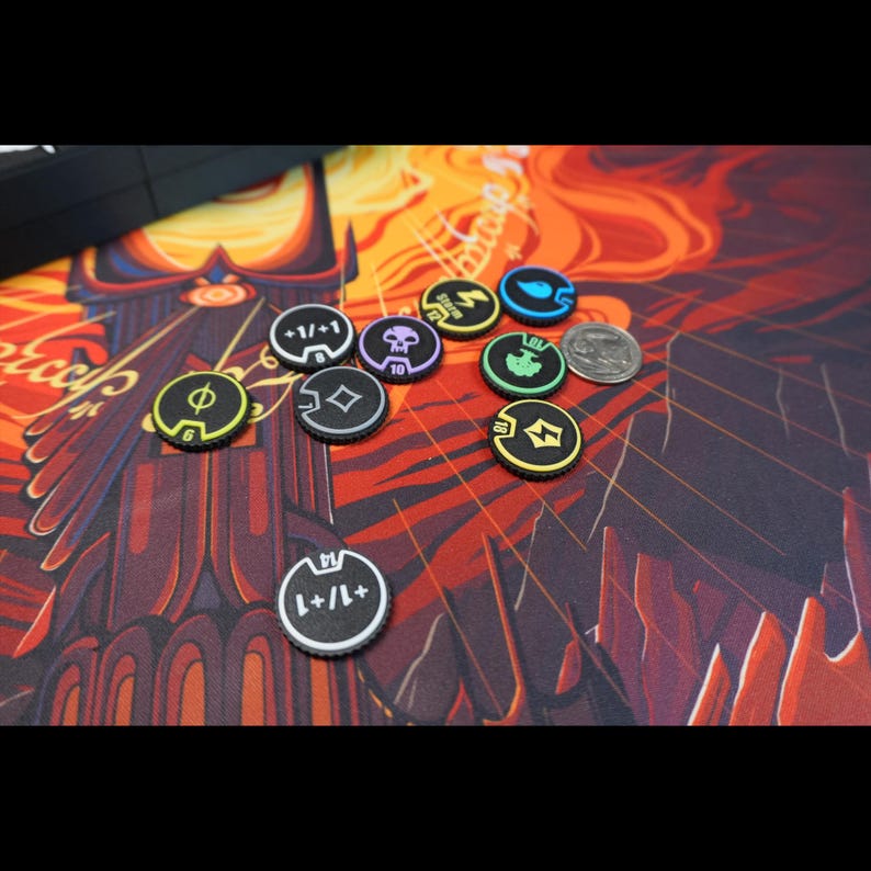 May include: A collection of small, round, black game tokens with colored edges and various white or colored icons and numbers printed on them, including symbols for storm, skull, tree, and +1/+1 counters, alongside a silver US quarter coin.