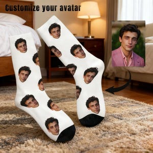 May include: White socks with a black heel and toe, featuring a repeating pattern of a person's face. The text "Customize your avatar" is at the top. The socks are displayed on a patterned rug.