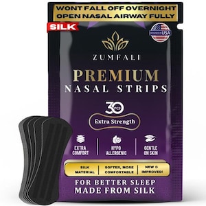 May include: A purple and gold ZUMFALI Premium Nasal Strips packet, designed in the USA, with the text "Wont Fall Off Overnight" and "Open Nasal Airway Fully". A stack of black nasal strips is visible. The packet states "Extra Strength" and "Made From Silk".