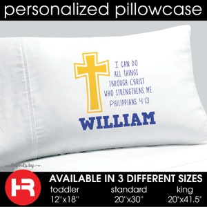 May include: A white pillowcase featuring a yellow cross graphic, the text I CAN DO ALL THINGS THROUGH CHRIST WHO STRENGTHENS ME. PHILIPPIANS 4:13 in blue, and the name WILLIAM in blue. Available in toddler 12x18 inches, standard 20x30 inches, and king 20x41.5 inches.