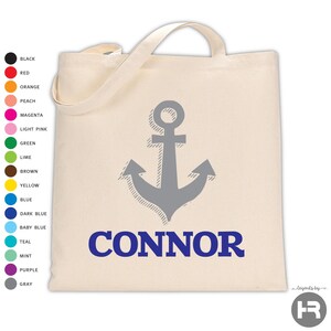 May include: A beige canvas tote bag featuring a centered gray anchor graphic and the name CONNOR printed in bold blue capital letters. To the left, a vertical list of sixteen colored circles displays available color options with labels.