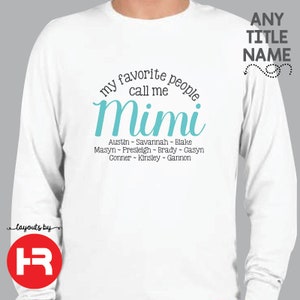 May include: White long-sleeve shirt with the text "my favorite people call me Mimi" in a teal blue font. Below the text are the names Austin, Savannah, Blake, Masyn, Presleigh, Brady, Casyn, Conner, Kinsley, and Gannon.