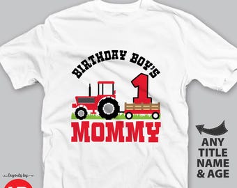 May include: White adult unisex t-shirt with a red tractor graphic, the number 1, and the words "BIRTHDAY BOY'S" and "MOMMY". The shirt design includes green grass and the text "ANY TITLE NAME & AGE".