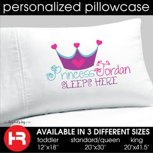 May include: White pillowcase with a pink crown and the text "Princess Jordan Sleeps Here". Available in three sizes: toddler (12" x 18"), standard/queen (20" x 30"), and king (20" x 41.5").