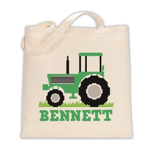 May include: A green canvas tote bag with a green tractor design and the name "BENNETT" printed in green letters.