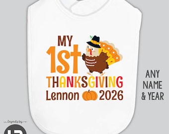 May include: A white baby bib featuring a graphic of a turkey wearing a pilgrim hat. The text reads MY 1st THANKSGIVING Lennon 2026, accompanied by an orange pumpkin illustration. The design uses orange, yellow, brown, and red lettering.