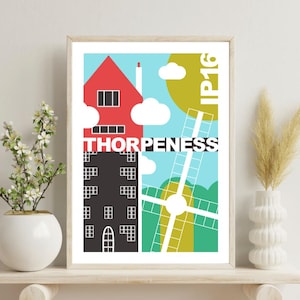 Può includere: Stampa artistica incorniciata con un'illustrazione colorata di una scena cittadina. L'opera d'arte include una casa rossa, un edificio nero, un mulino a vento e la parola "THORPENESS". Lo sfondo è un mix di blu, verde e giallo.