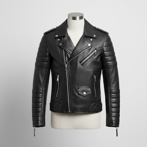 May include: Black leather jacket with a classic biker style. Features include a notched collar, asymmetrical zip closure, multiple zippered pockets, and quilted detailing on the shoulders and sleeves. The jacket is displayed on a mannequin.