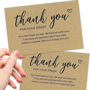May include: Two rectangular kraft paper thank you cards with black printed text. The cards feature the words thank you for your order in a script font with a small heart icon, followed by a message about customer satisfaction and contact info.