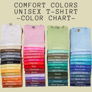 May include: A Comfort Colors unisex t-shirt color chart displaying four vertical stacks of folded shirts in various shades. The text at the top reads COMFORT COLORS UNISEX T-SHIRT -COLOR CHART- with labels for each color listed next to the stacks.
