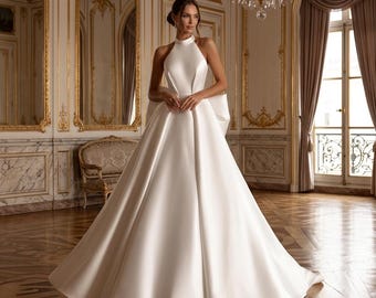 Halter Neck Satin A-Line Wedding Dress: Open Back Bridal Gown with Statement Bow