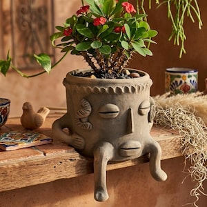 May include: A set of three ceramic mugs with a speckled, matte finish. The mugs are in shades of cream, light gray, and dark gray. Each mug has a simple, minimalist design and a rounded handle. The mugs are suitable for coffee, tea, or other beverages.