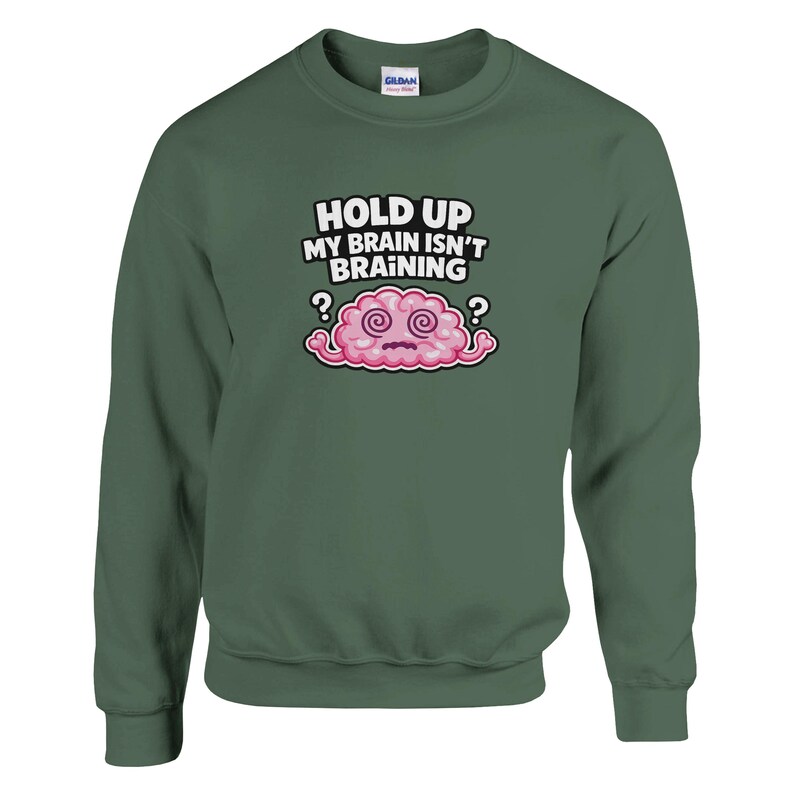 May include: A dark green sweatshirt featuring the text "HOLD UP MY BRAIN ISN'T BRAINING" and a cartoon brain. The brain is pink with swirling eyes and question marks on either side.