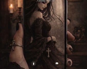 May include: A smartphone displays a gothic-style illustration of a woman in a dark dress, holding a rosary with a cross. The screen shows the time 11:23 and the date Tuesday, April 23. The phone is held by a hand with a ring.