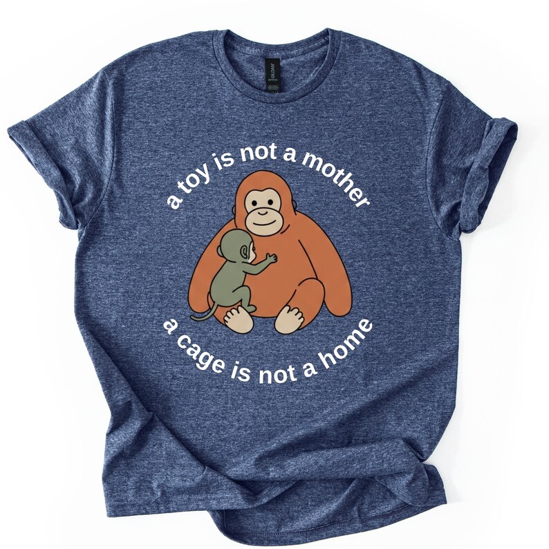 May include: Blue t-shirt with a graphic of an orangutan and baby orangutan. The text on the shirt reads "a toy is not a mother, a cage is not a home."