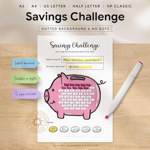 May include: A printable savings challenge sheet with a pink piggy bank design. The sheet includes prompts for savings goals and amounts, with the text "Savings Challenge" at the top. A white marker with a pink tip rests on the wooden surface.