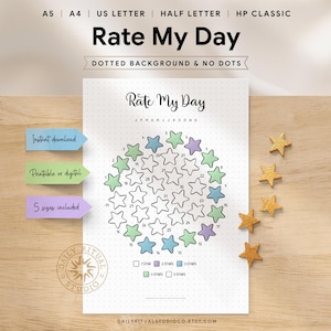 Rate My Day printable displayed on a wooden desk. The page features a circular star-shaped monthly tracker with numbered days, where stars are coloured to rate each day from 1 to 5 stars. A legend shows 1 star through 5 stars. Text indicates instant download, printable or digital use, dotted or plain background options, and five sizes included: A5, A4, US Letter, Half Letter, and Happy Planner Classic.