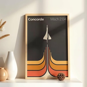 Könnte beinhalten: Ein gerahmter Kunstdruck mit einem Retro-Design der Überschall-Concorde. Das Kunstwerk hat einen schwarzen Hintergrund mit einer weißen Jet-Illustration und orange, gelben und roten geschwungenen Linien. Der Text "Concorde Mach 2.04" steht oben.