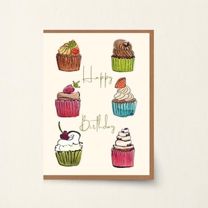 May include: A birthday card with a brown border. It features watercolour illustrations of six cupcakes with different toppings. The words "Happy Birthday" are written in gold script across the centre.