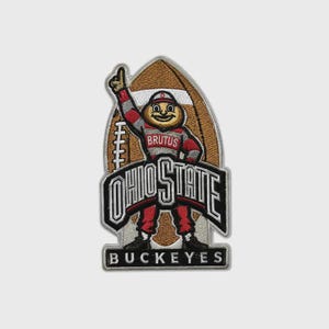 May include: An embroidered patch featuring a brown football shape with a mascot character wearing a red and gray uniform with the text BRUTUS on the chest. The design includes the text OHIO STATE in large letters and BUCKEYES at the bottom.