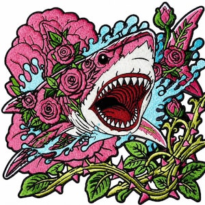 May include: An embroidered patch featuring a shark with an open mouth, surrounded by large pink roses, green leaves, thorny stems, and splashes of light blue water. The design uses vibrant pink, red, white, green, and blue thread colors.