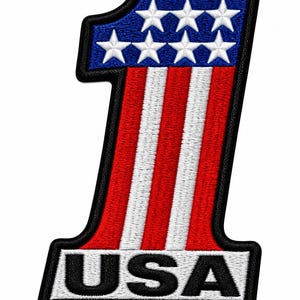 May include: An embroidered patch in the shape of the number one, featuring a blue top section with seven white stars and a lower section with vertical red and white stripes. The base of the patch includes a white rectangular border with USA text.