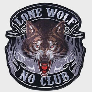 May include: A circular embroidered patch featuring a snarling wolf head with red eyes and bared teeth. The design includes grey flame accents and black banners with the white text LONE WOLF at the top and NO CLUB at the bottom, all outlined in black.