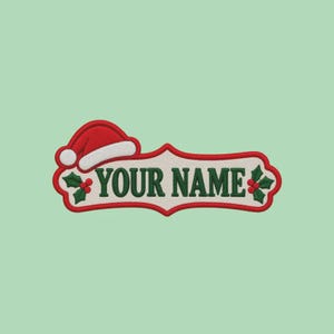 May include: An embroidered patch featuring a cream-colored center with the text "YOUR NAME" in dark green letters. The design is bordered in red and decorated with a red Santa hat on the left and green holly leaves with red berries.