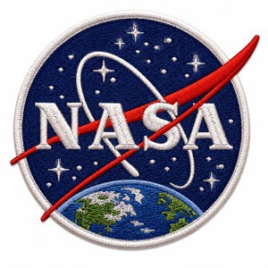 Może przedstawiać: Okrągła haftowana naszywka z logo NASA w białym kolorze na ciemnoniebieskim tle. Wzór zawiera czerwony łuk, biały pierścień orbitalny, białe gwiazdy oraz przedstawienie Ziemi w kolorach zielonym i niebieskim w dolnej części naszywki.