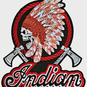 May include: An embroidered patch featuring a skull wearing a feathered headdress, centered within a red rope border. Two crossed tomahawks are positioned behind the skull. Below the circular design, the word Indian is stitched in white script.