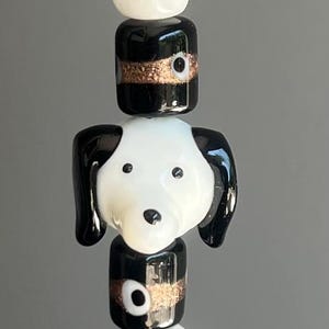 May include: A set of three ceramic mugs with a speckled, matte finish. The mugs are in shades of cream, light gray, and dark gray. Each mug has a simple, minimalist design and a rounded handle.