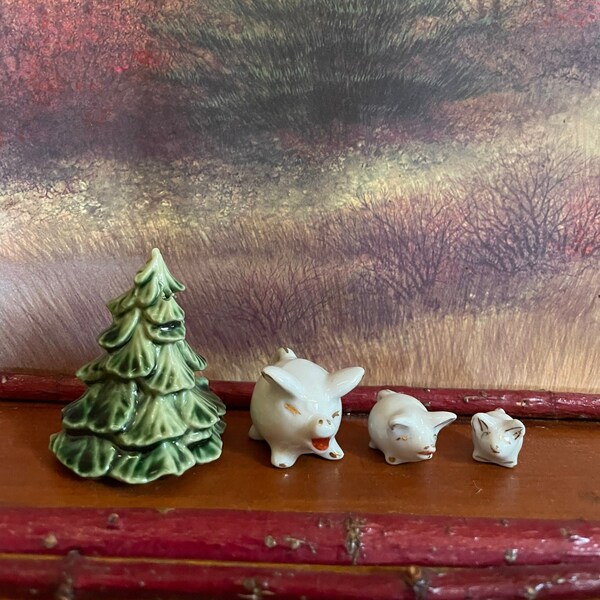 Set of three miniature porcelain pigs