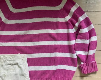 May include: A pink and white striped sweater with the text "NORTHERN ISLES" on the tag.