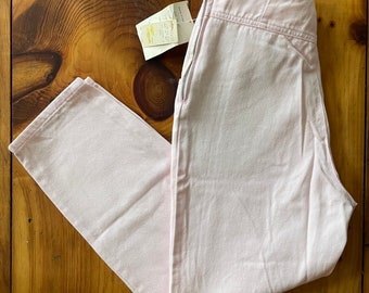May include: A pair of light pink pants with a zipper fly and a high waist.