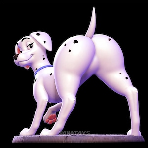 Può includere: Statuetta di cane dalmata bianco con macchie nere, un collare blu e un'espressione sorridente. Il cane è in posa giocosa, con il posteriore rivolto verso l'osservatore. La statuetta è su una base rettangolare.