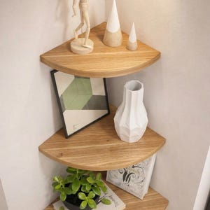 May include: A set of three ceramic mugs with a speckled, matte finish in cream, light brown, and dark brown. Each mug features a minimalist design, ideal for tea or coffee.