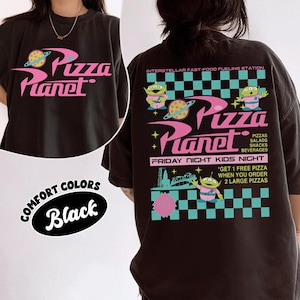 May include: Black t-shirt featuring the Pizza Planet logo in pink and white. The back of the shirt has the Pizza Planet logo, alien characters, and text that reads "Interstellar Fast-Food Fueling Station" and "Friday Night Kids Night."