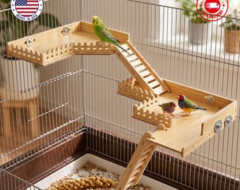 May include: A multi-level wooden bird perch system installed inside a wire cage. The structure features two connected platforms with decorative picket-style fencing, two slanted ladders for climbing, and metal hardware for secure attachment.