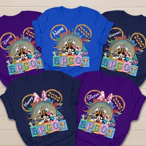 May include: A collection of five short-sleeved t-shirts in shades of blue and purple. Each shirt features a graphic print of Disney characters, the Epcot geodesic sphere, the text EPCOT, and the year 2026, with personalized labels like Daddy, Name, Brother, Mommy, and Sister.