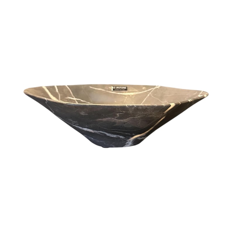 May include: A dark gray, stone vessel sink with white veining. The sink has a unique, angular shape with gently sloping sides. The interior is a solid dark gray, and the exterior features a marble-like pattern. The sink is designed for bathroom use.