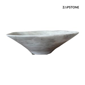 May include: A white marble bowl with a unique, asymmetrical shape. The bowl has a wide, open top and tapers down to a narrow base. The marble has subtle gray veining throughout. The brand name "ZAPSTONE" is printed in black on the upper right.