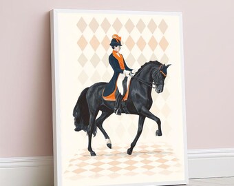 May include: A framed art print depicts a rider on a black horse in a dressage pose. The rider wears a blue and orange uniform. The background features a diamond pattern in beige and peach tones. The artwork is displayed against a pale pink wall.