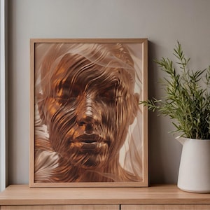 May include: A framed artwork featuring a detailed, golden-toned face with closed eyes. The face is composed of flowing, textured lines, creating a unique artistic effect. The artwork is set against a soft, neutral background.