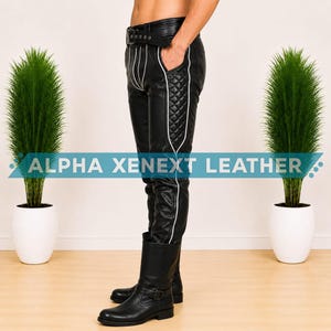 May include: Black leather pants featuring a belted waist, white piping accents, and quilted side panels. The pants are paired with black leather boots. The text ALPHA XENEXT LEATHER is displayed across the center of the image in white letters.