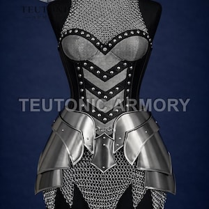May include: A silver and black medieval armour set displayed on a mannequin. The armour includes a chainmail collar, a studded bodice, and metal plates. The text "TEUTONIC ARMORY" is visible.