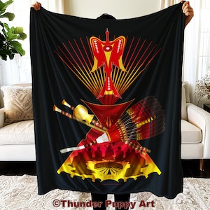 May include: A black throw blanket with a colorful design featuring a stylized bird, feathers, and geometric shapes. The design is centered on the blanket and has a red, yellow, and orange color scheme.